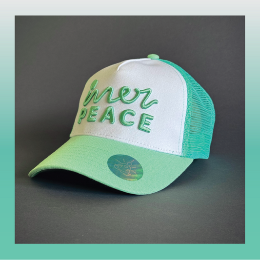 Green and white cap with 'inner peace' text on a white background